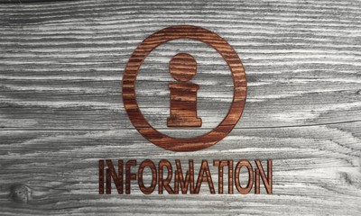 Information symbol in a wooden background