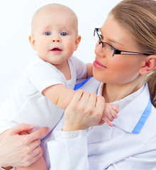 Pretty doctor pediatrician holding hand of sweet infant
