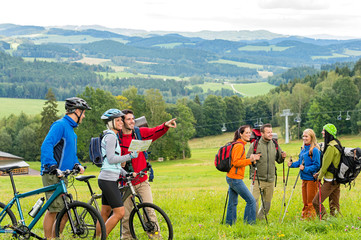 Hikers helping cyclists following track nature landscape
