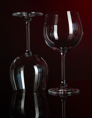 Two glasses on dark red background