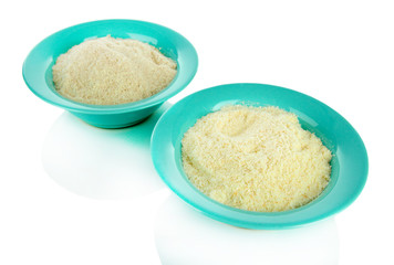 Powdered milk in bowls for baby isolated on white