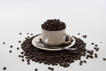 Coffee Beans Overflow Coffee Cup on Isolated White Background