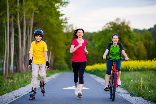 Active family - mother and kids running, biking, rollerblading