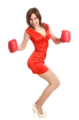 Woman in red, wearing boxing gloves, isolated on white