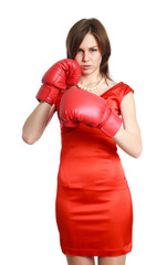 Woman in red, wearing boxing gloves, isolated on white