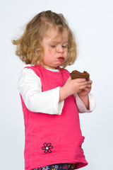 little girl is eating chocolate cake