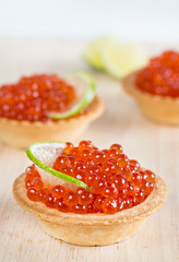 Tartlets with red caviar and lime