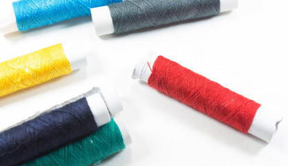 the white background of the coils with colorful thread spools