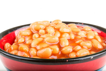 Marinated haricot beans in tomato sauce with shallots on a plate