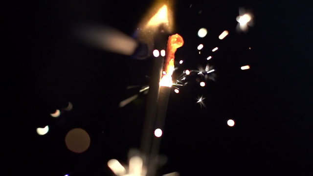 a sparkler being ignited making abstract pattern in slow motion