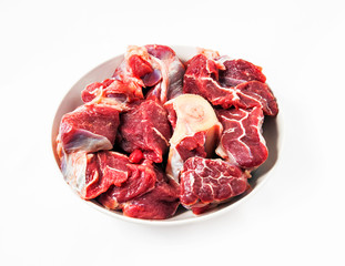 red raw meat over white