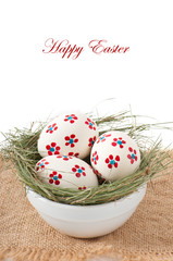 Easter eggs in a bowl decorated with a nest