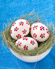 Easter eggs in a bowl decorated with a nest