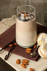 Glass of chocolate-cream cocktail on wooden table close-up