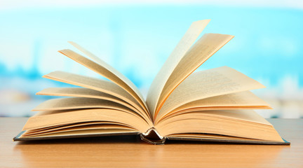 Opened book on bright background