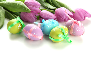 Bright easter eggs and tulips, isolated on white