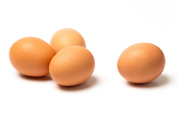 Four eggs with shadows isolated on white background