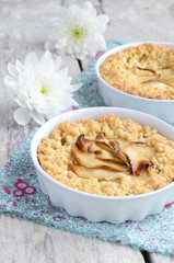 Homemade apple pie and white flowers on wooden table