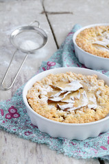 Sugared apple pies on wooden background