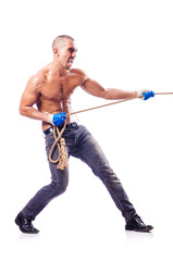 Muscular man pulling the rope