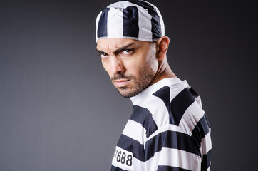 Obraz premium Convict criminal in striped uniform