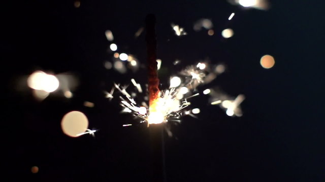 a sparkler being ignited making abstract pattern in slow motion