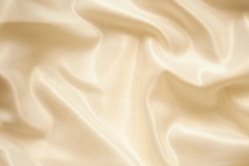 Texture background. Beautiful silky brilliant wavy fabric