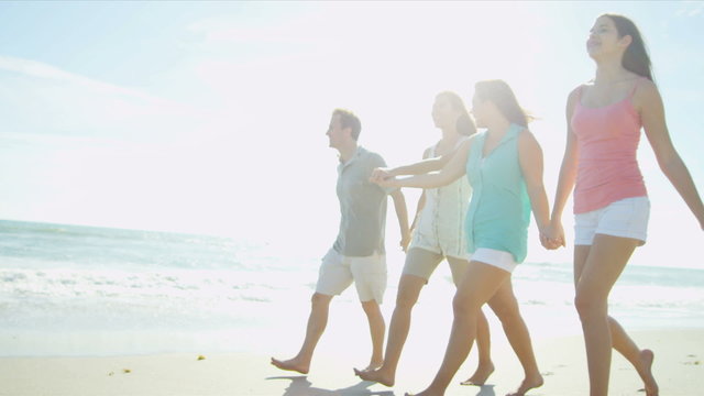 Happy Caucasian Family Group Walking Beach