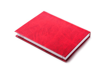 Closed red book on white background