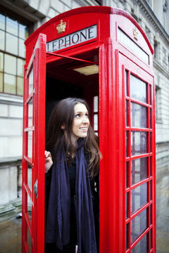 Tourist in London on a public telephone