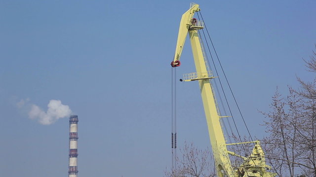 construction crane and pipe with a smoke.