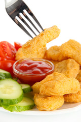 Fried chicken nuggets with sauce and vegetables isolated