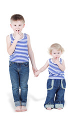 Two boy brothers in striped singlets and jeans stand