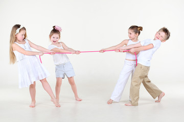 Four cute little boys and girls overtighten pink rope