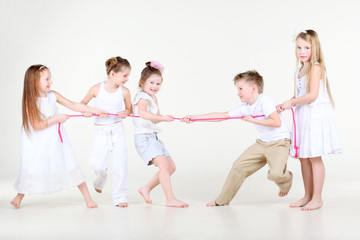 Four happy little girls and one boy  draw over pink rope