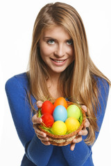 Fototapeta na wymiar Smiling woman holding basket with Easter eggs