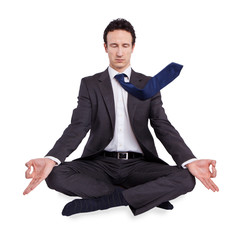 young businessman meditating in yoga lotus pose on white backgro