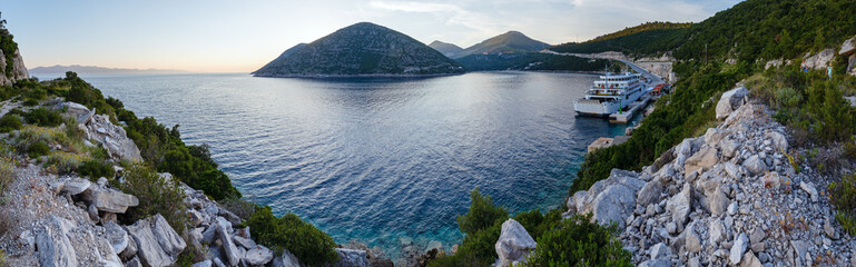 Evening summer coastline with cargo ship  (Ston, Croatia) and fa
