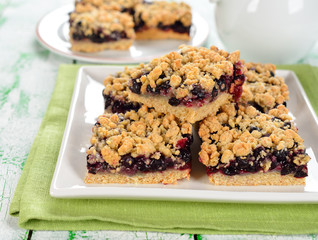 Cake with black currant on a white table