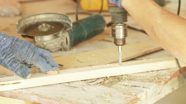 Drilling of wooden beams. Drilled through a wooden board and