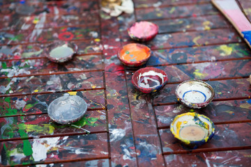 Jars with multicolored paints on table