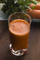 carrot juice on a wooden background