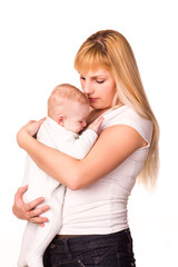 Young beautiful mother hugging cute little baby