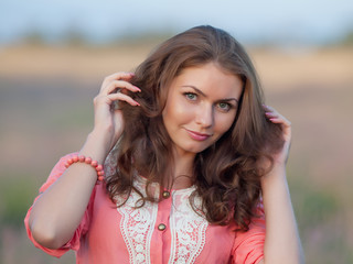 Naklejka premium Young woman in the field of blossoming lavender