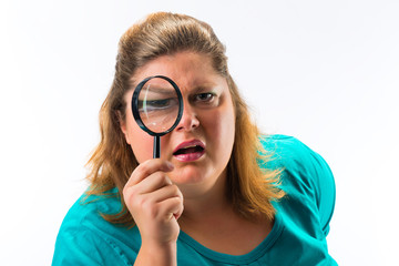 Woman looking through magnifying glass or loupe