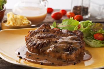 closed up grilled steak flavoured with  pepper and gravy