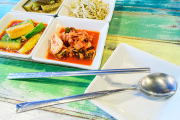 Korean cuisine, Kimchi on white square dish with spoon and Chops