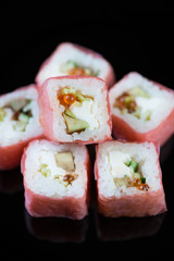 Vertical shot of a sushi set on a black plate
