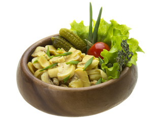 Marinated mushrooms in white saucer isolated on white