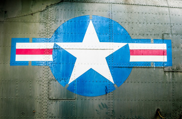 Military plane with star and stripe sign.
